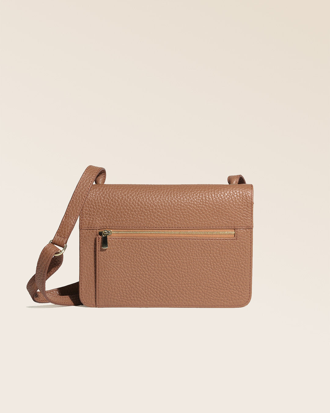 Notre pochette Fréhel en cuir façon vigogne fauve vue de dos en studio.