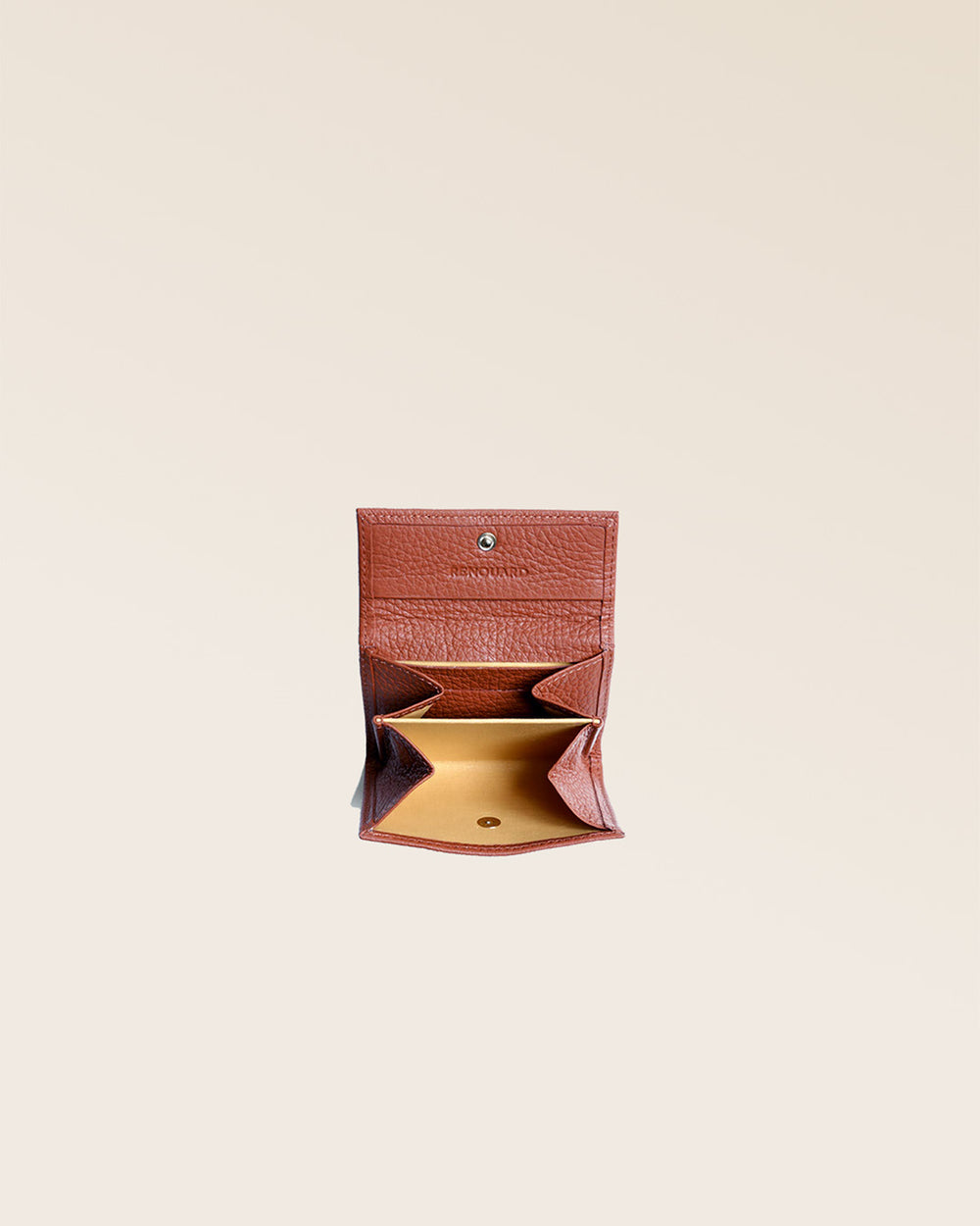 Notre porte-monnaie Mixte en cuir façon vigogne terracotta vu ouvert en studio.