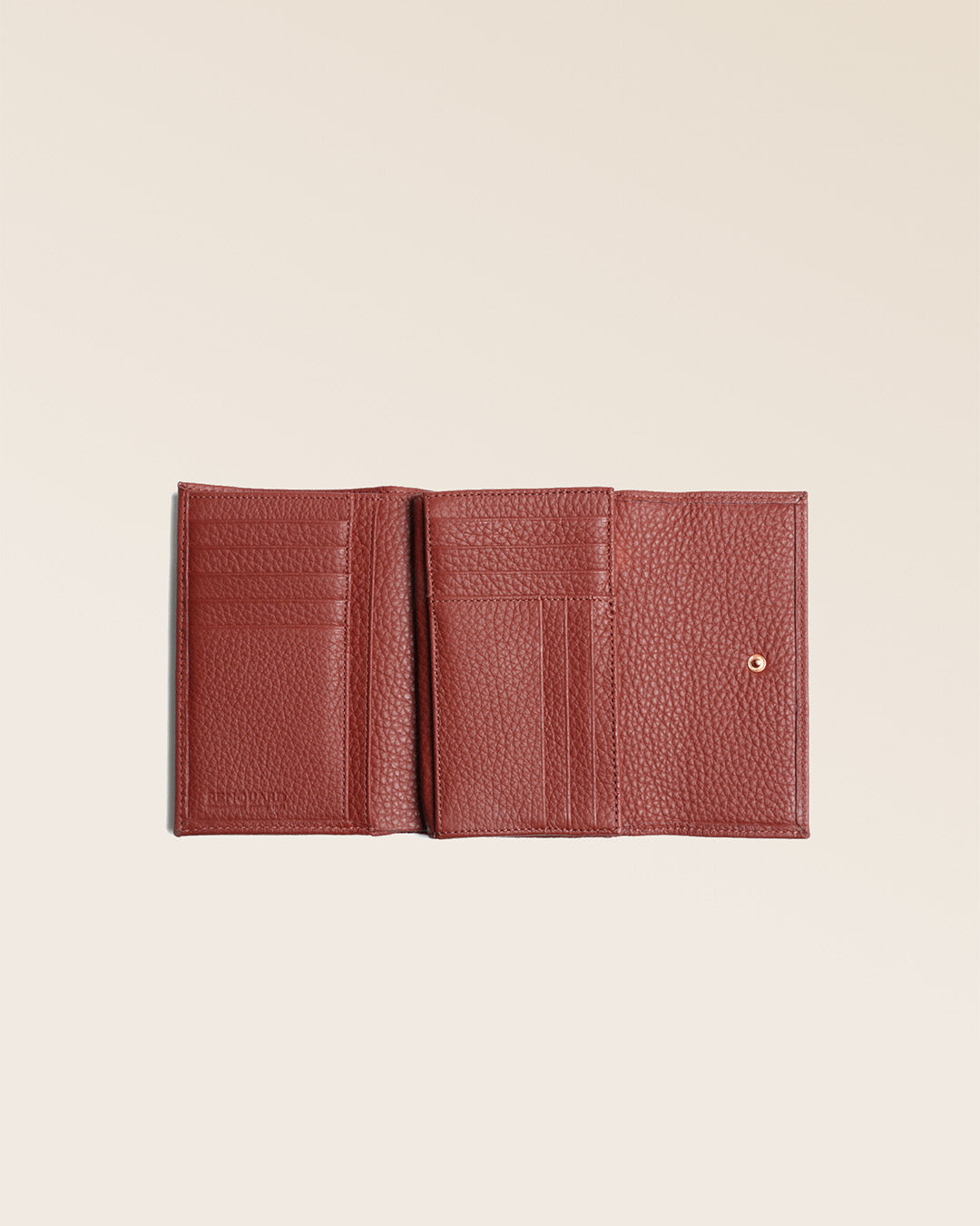 Notre porte-monnaie Opale en cuir façon vigogne terracotta vu ouvert en studio.