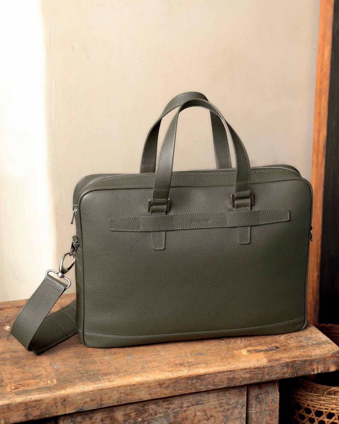 Notre sac cartable Boston en cuir façon vigogne kaki vu de face en ambiance.