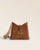 Notre sac Cob Renouard dans sa version petit modèle, cuir veau velours noisette et bandoulière coton camel ; vu de face en studio.