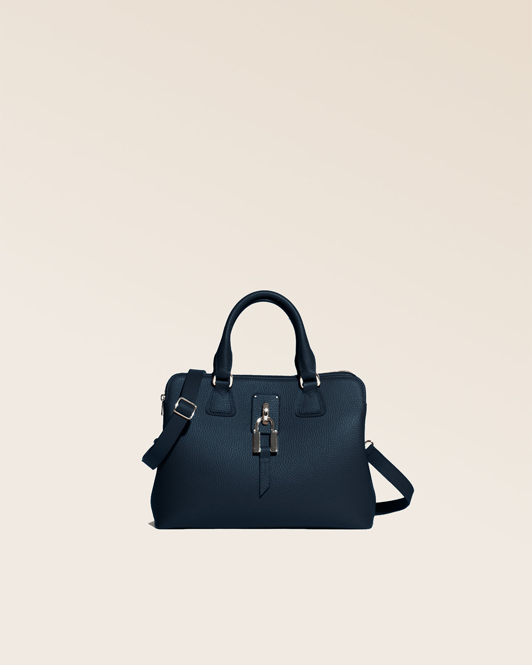 Notre sac New-York Renouard, dans sa version Mini, en cuir façon vigogne bleu marine et accessoires dorés, vu de face en studio.